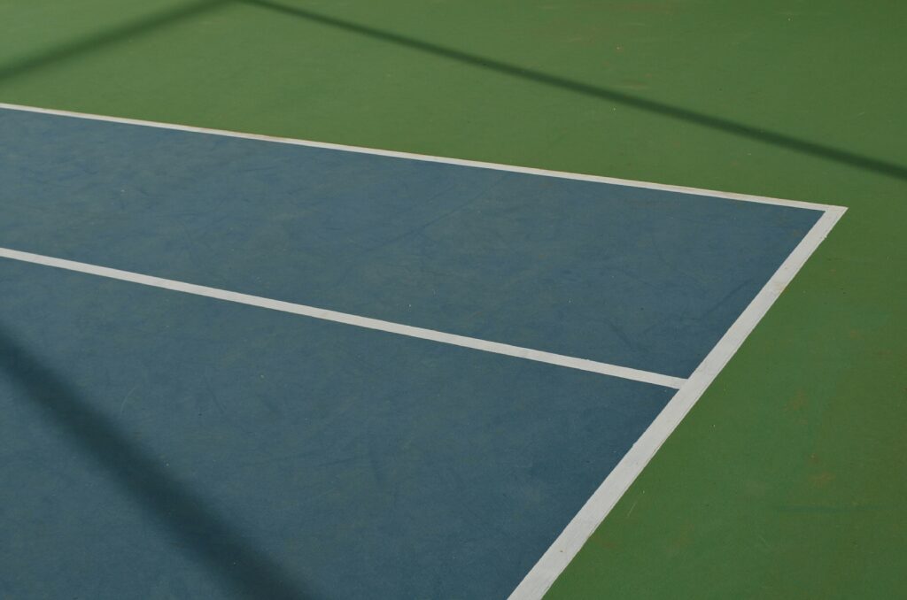 Close-up of intersecting boundary lines on a court, symbolizing the importance of setting healthy boundaries for emotional balance and stronger relationships.