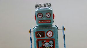 A vintage toy robot with a blank expression, symbolizing the risks of relying on artificial intelligence like ChatGPT for relationship advice and emotional attachment.